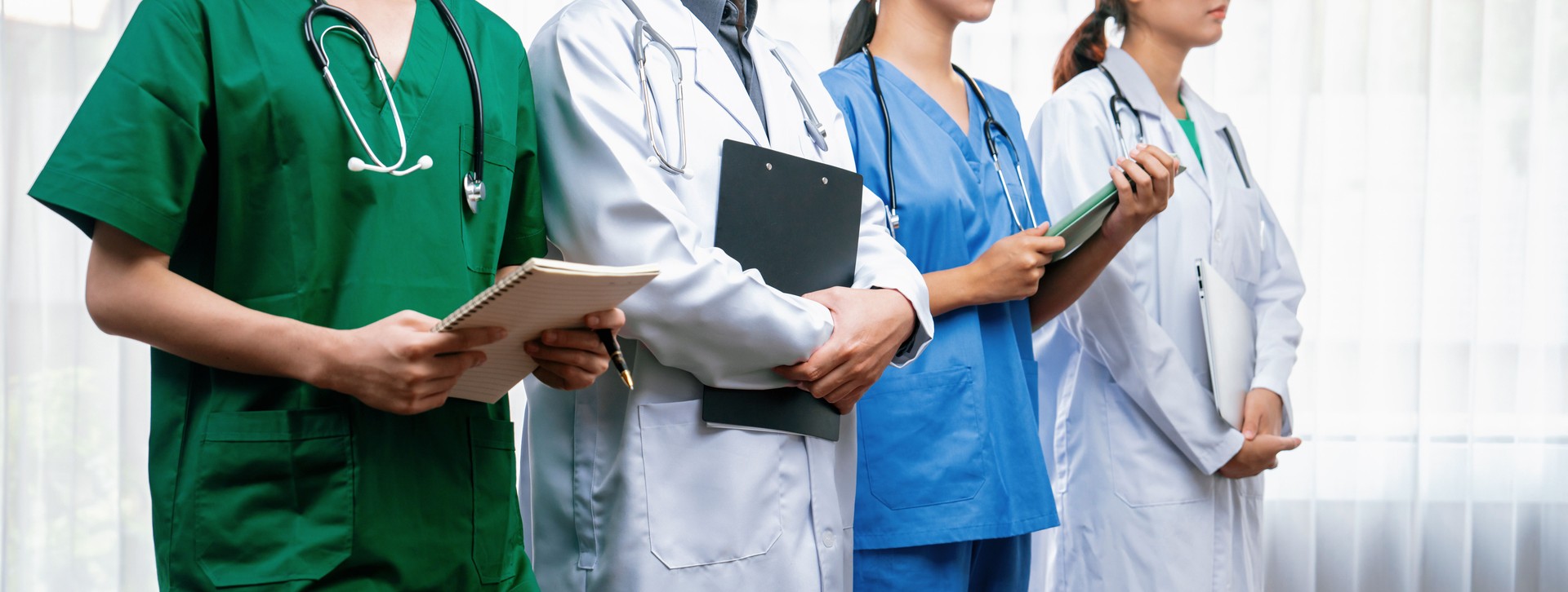 Confident and professional team of medical staff stand in line together. Rigid